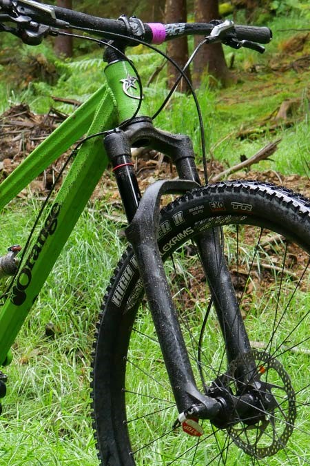 Image shows the front fork and handlebars of the bike 
